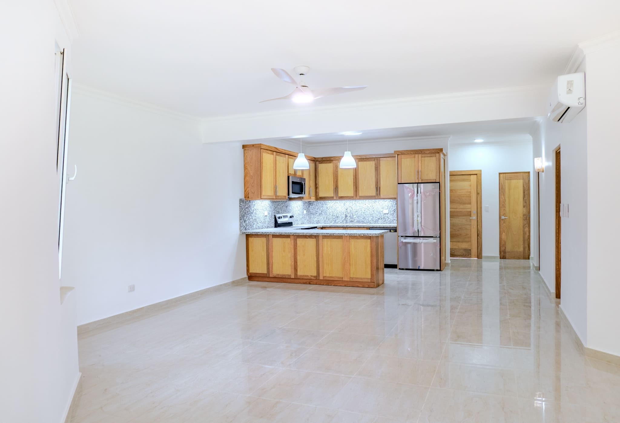 Open-plan living area and kitchen in 2-bedroom Hispaniola Beach condo in Sosua