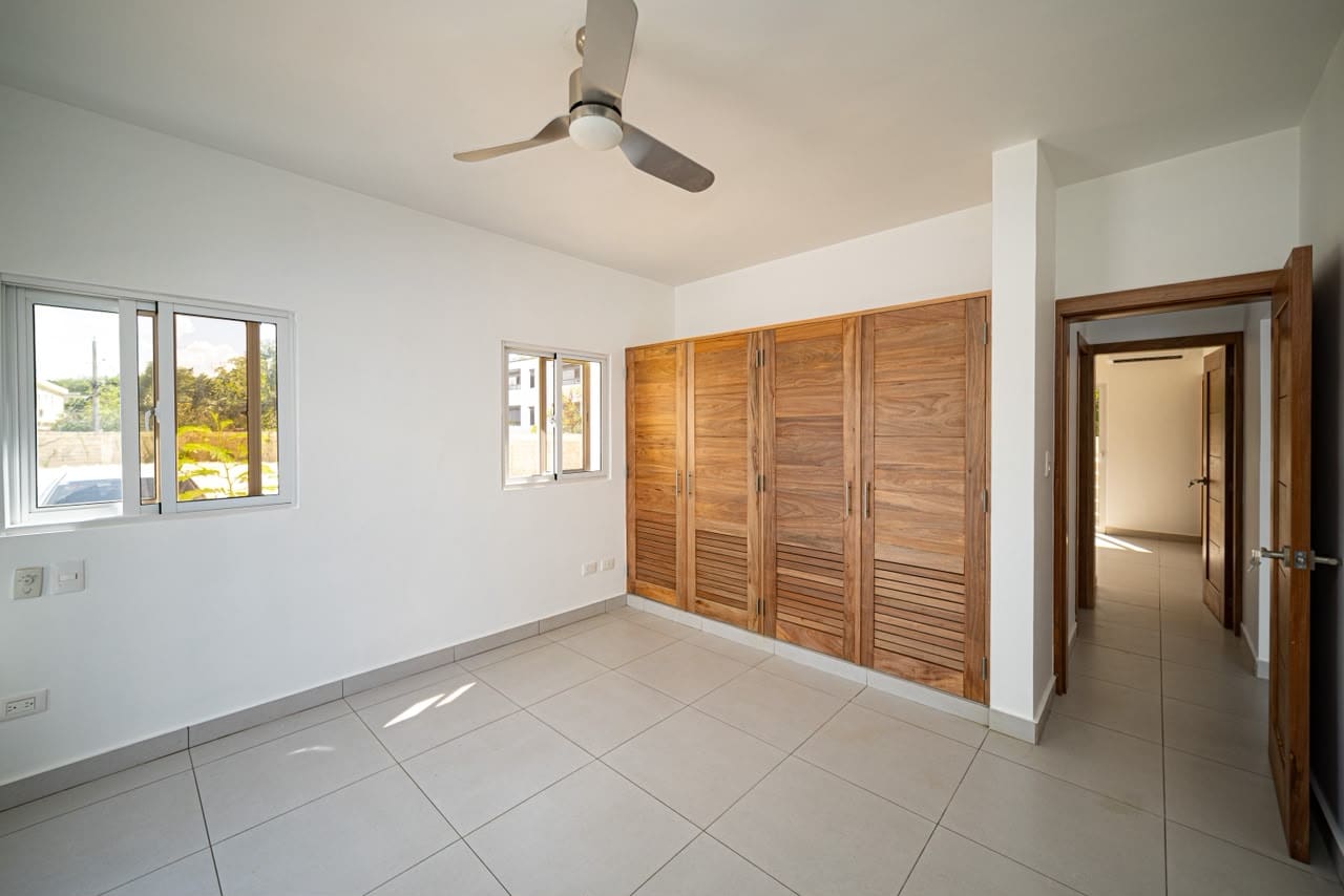 buyDRproperty Modern bedroom with wooden built-in wardrobes and ceiling fan. Sosua Real Estate