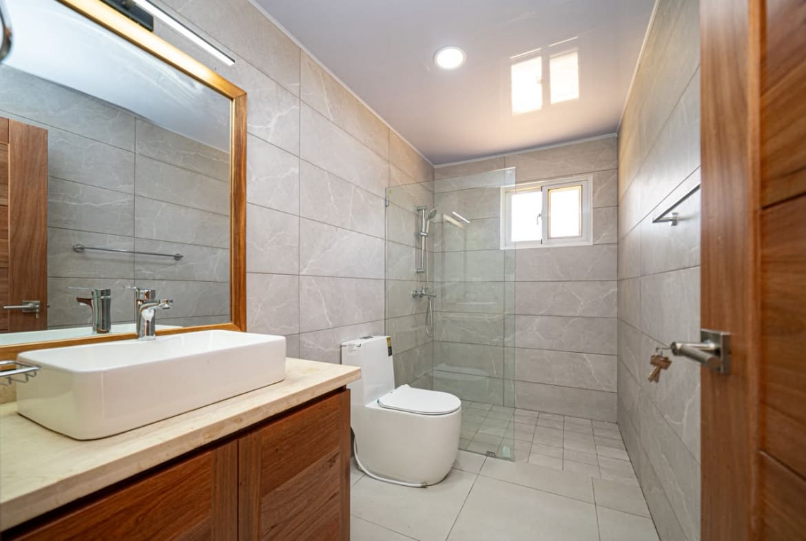 buyDRproperty Modern bathroom with vessel sink, wood vanity, and glass shower Sosua Real Estate