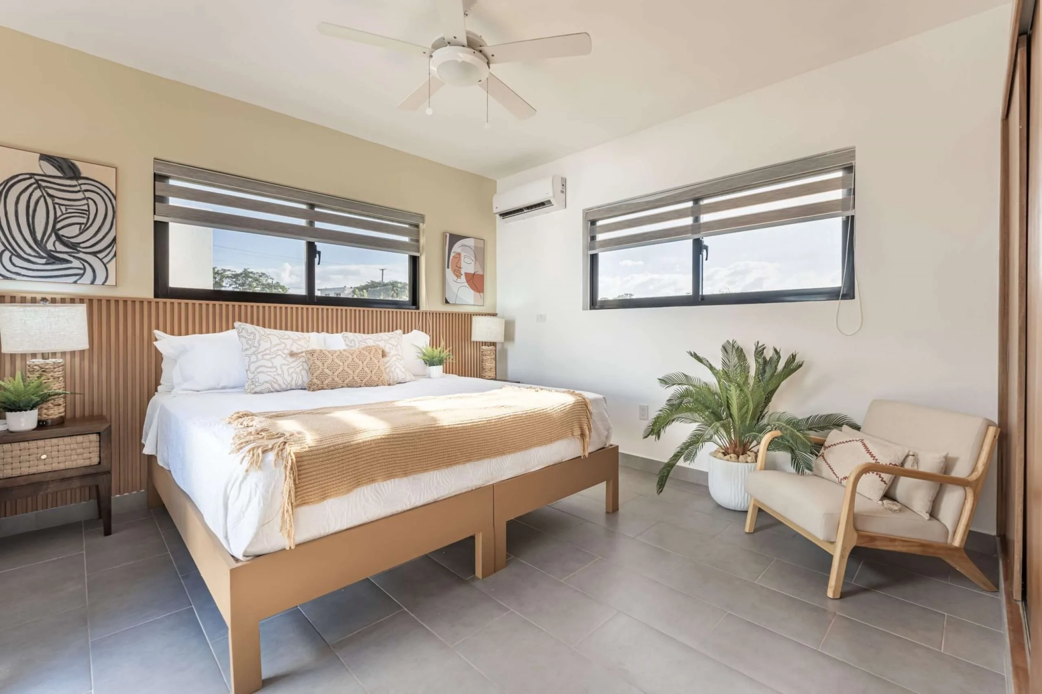 buyDRproperty Modern bedroom with king-size bed, neutral bedding, and natural light Sosua Real Estate