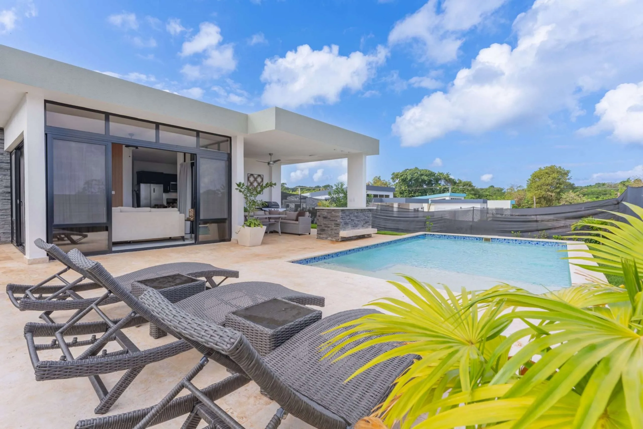buyDRproperty Modern villa with pool and lounge chairs, perfect for luxury vacation rentals. Sosua Real Estate