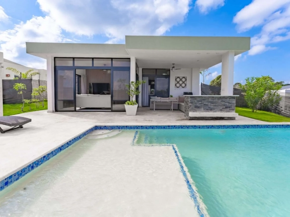 buyDRproperty Modern villa with swimming pool and outdoor seating area Sosua Real Estate