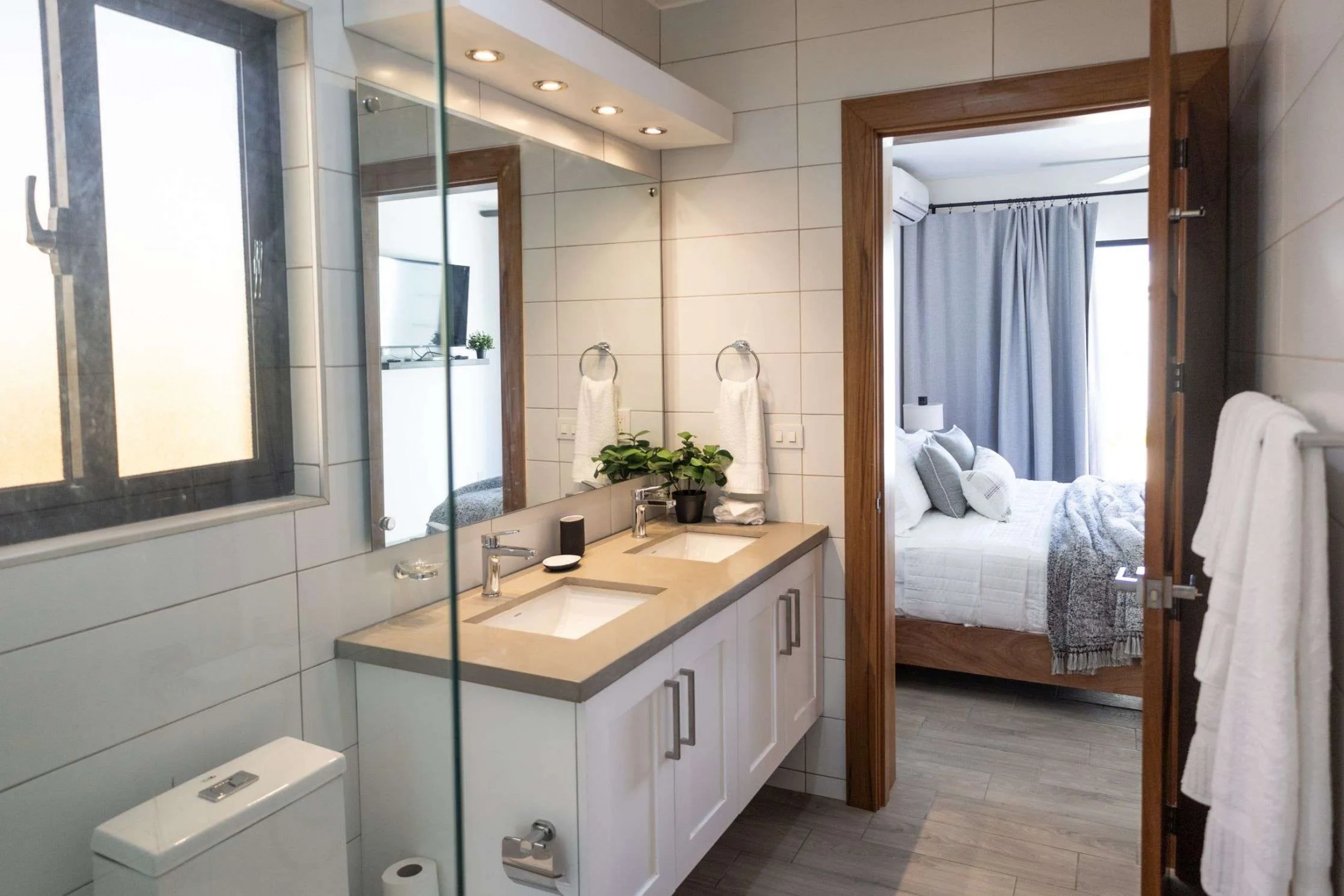 buyDRproperty Modern bathroom with double vanity and view into bedroom Sosua Real Estate