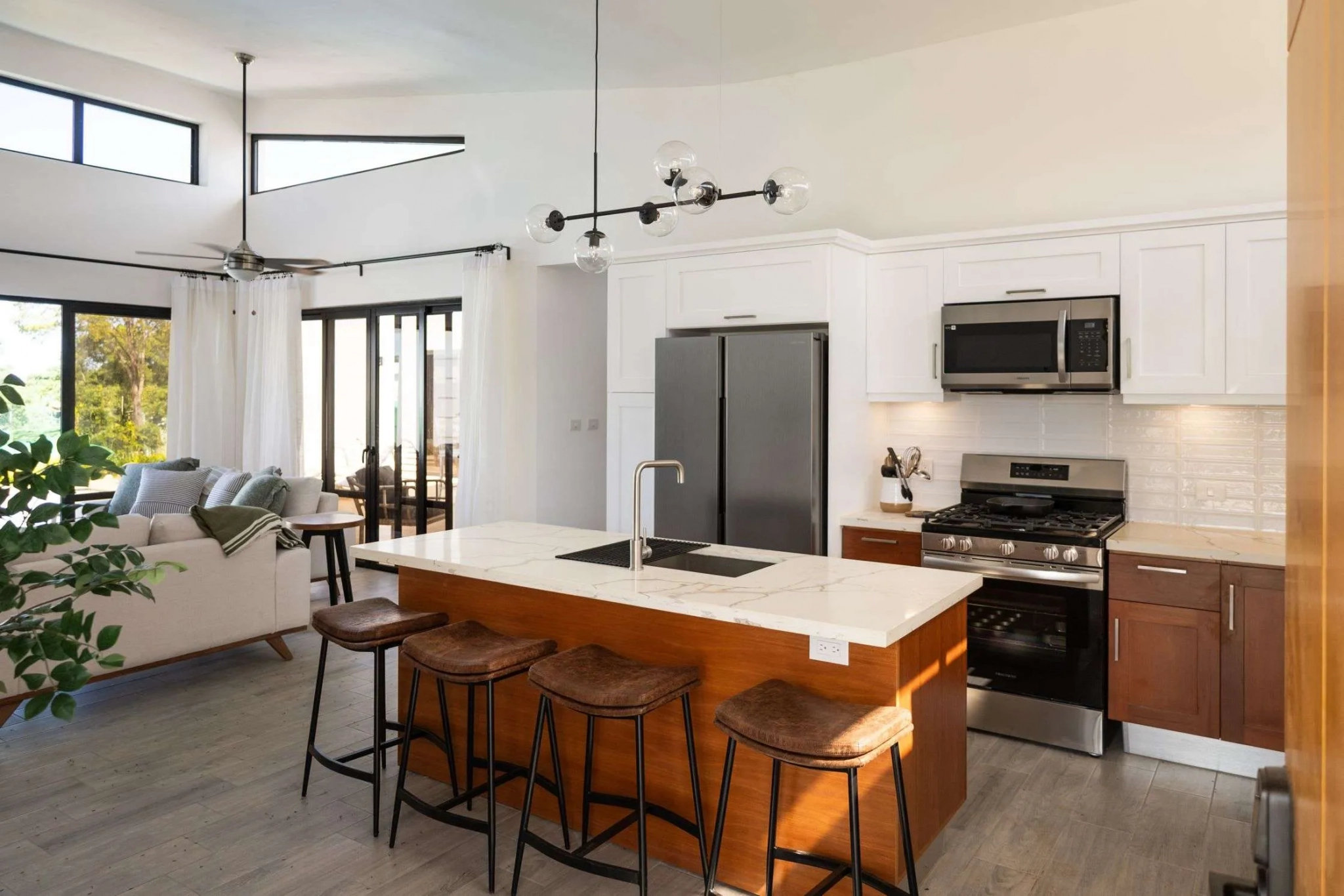buyDRproperty Modern kitchen island with seating and stainless steel appliances Sosua Real Estate