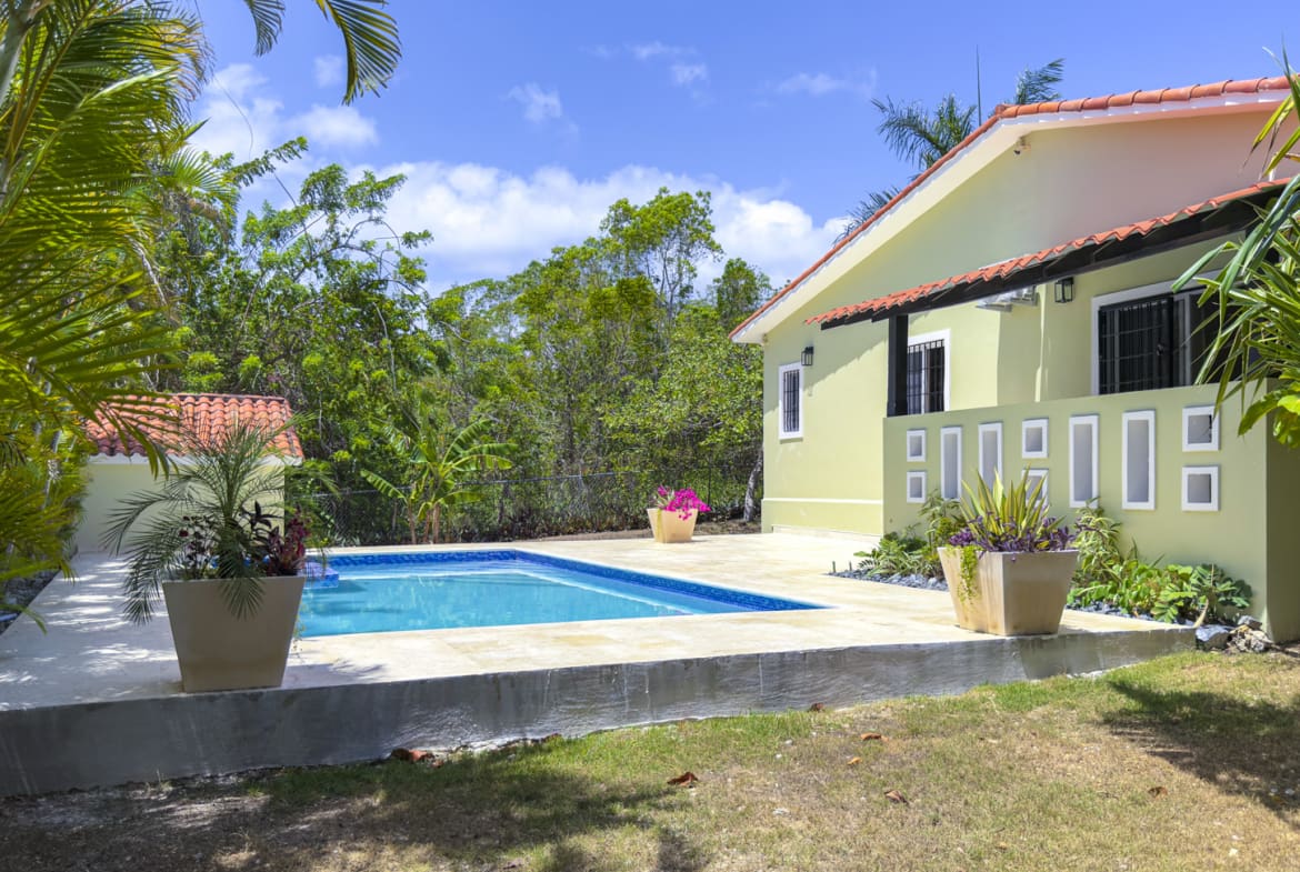 Tropical Sosua villa with pool, palm trees, and lush greenery