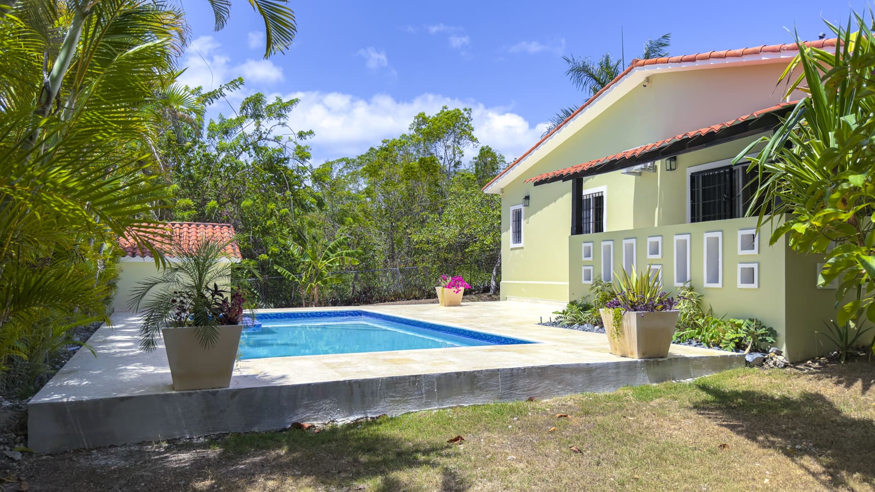 Tropical Sosua villa with pool, palm trees, and lush greenery