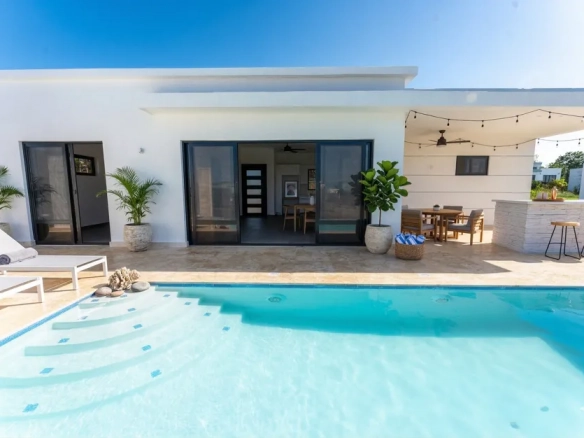 buyDRproperty Modern white villa with a private pool, outdoor dining, and bar Sosua Real Estate