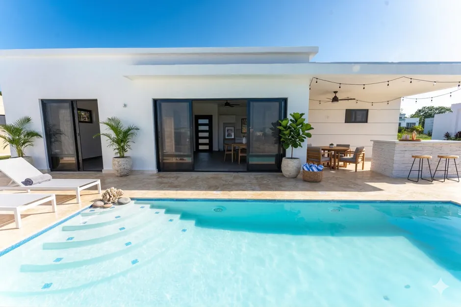 buyDRproperty Modern white villa with a private pool, outdoor dining, and bar Sosua Real Estate