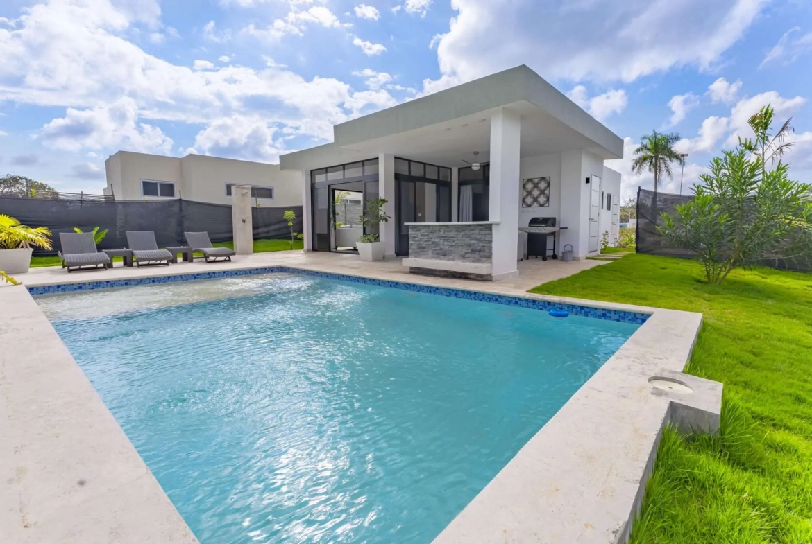 buyDRproperty Modern villa with swimming pool, outdoor bar, and grill in sunny weather Sosua Real Estate