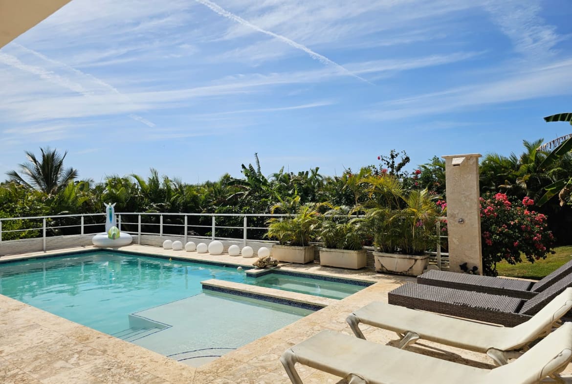 buyDRproperty Luxury villa with pool, lounge chairs, and tropical garden Sosua Real Estate