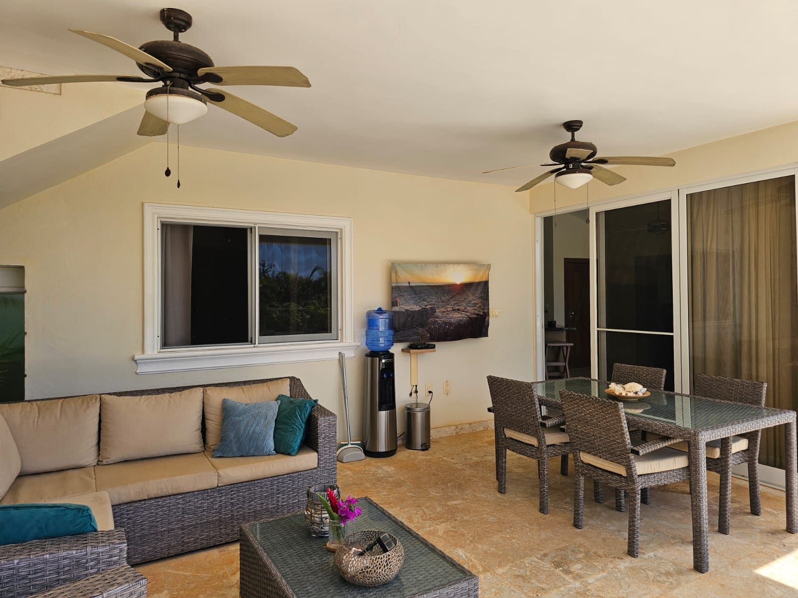 buyDRproperty Covered patio with seating, dining table, water cooler, and ceiling fans. Sosua Real Estate