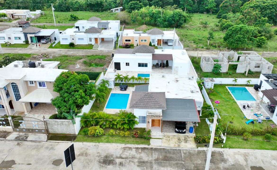 Aerial view of modern houses with swimming pools in a suburban neighborhood