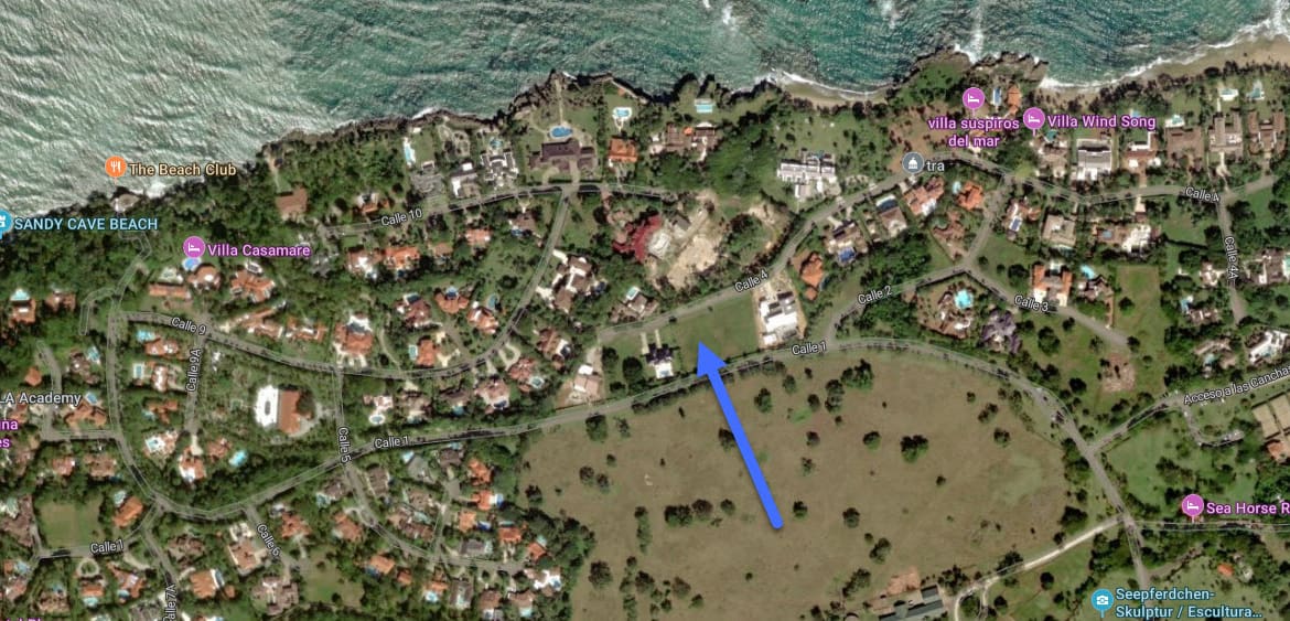 Aerial view of a tropical coastline with villas and roads