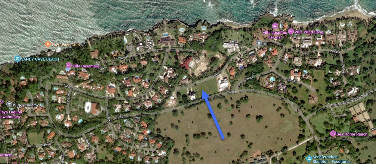 Aerial view of a tropical coastline with villas and roads
