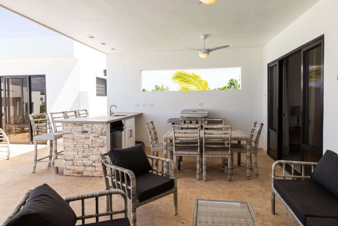 buyDRproperty Outdoor patio dining area with grill, bar, and seating Sosua Real Estate