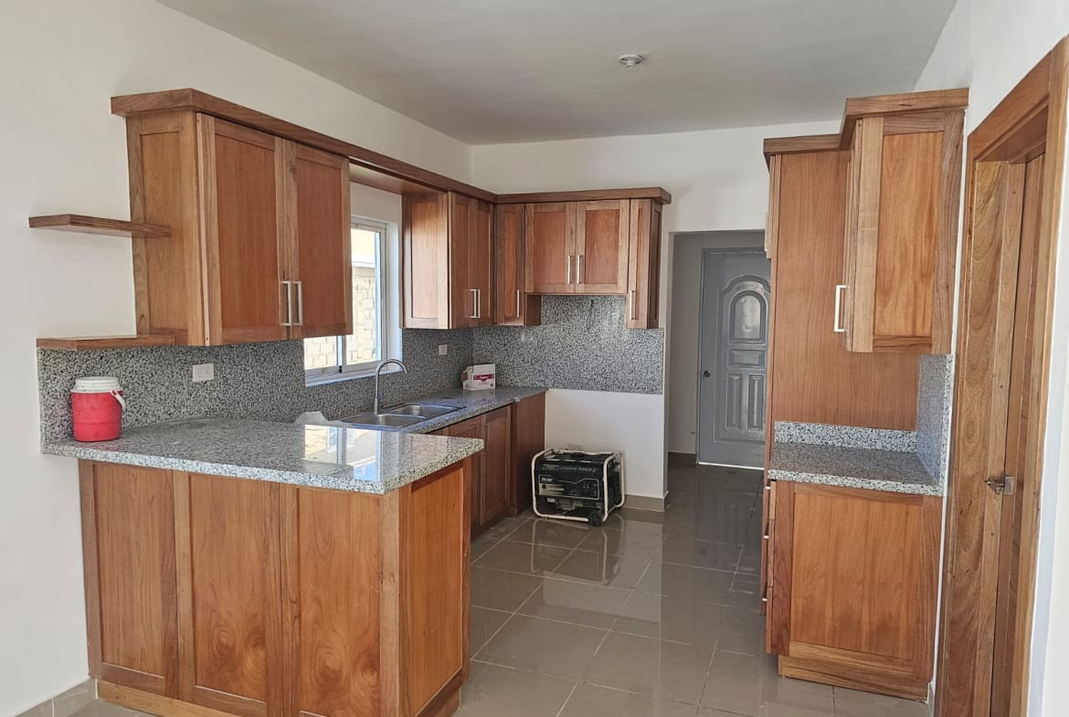 Wood kitchen cabinets and granite countertops in a modern kitchen.