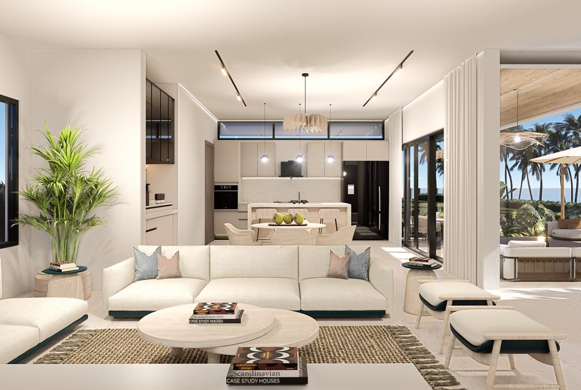 Modern living room and kitchen with white sectional sofa, dining table, and ocean view.