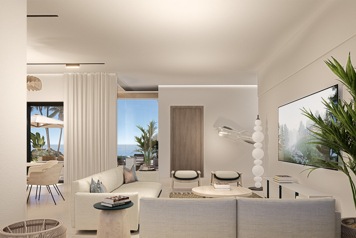Bright, modern living room with ocean view, white sofa, and minimalist decor