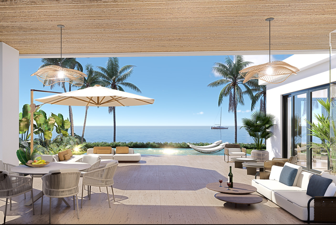 Luxury outdoor patio with ocean view, lounge chairs, dining table, and pool