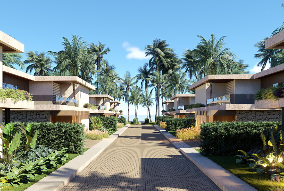 Modern villa complex with palm trees and a paved walkway