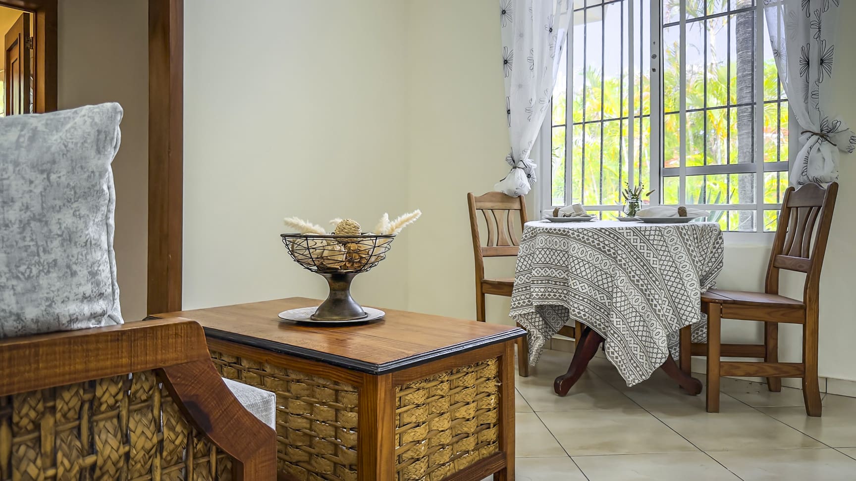 Cozy dining area with a wooden table, chairs, and a decorative bowl.