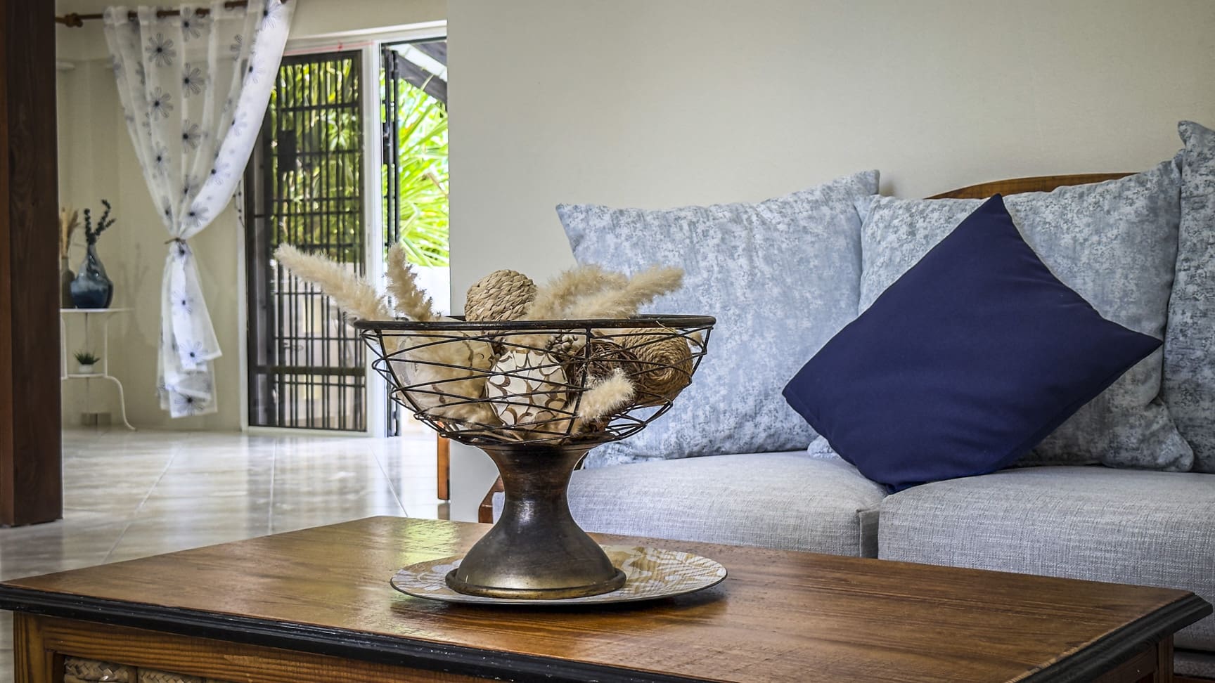 Decorative bowl with natural elements on a coffee table in a living room.
