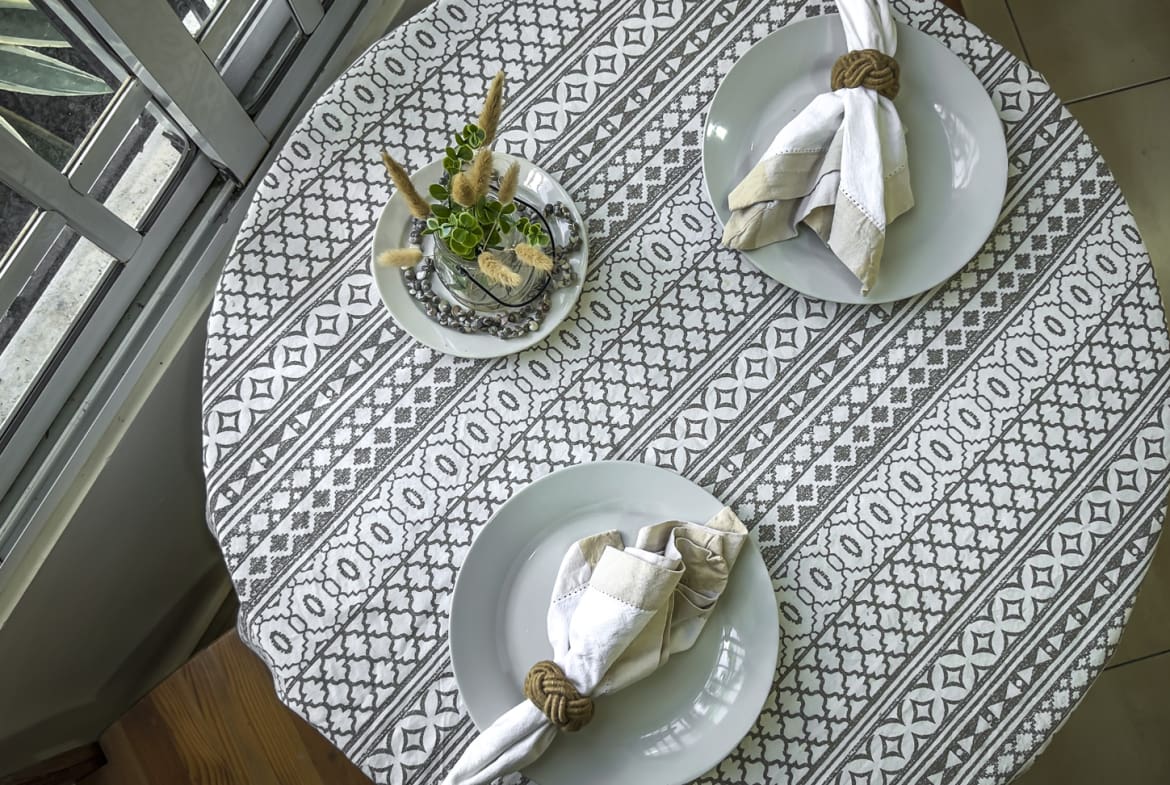 Table setting for two with white plates, napkins, and a centerpiece