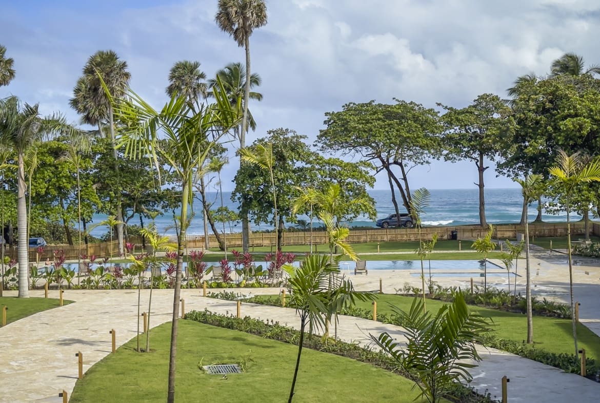 Tropical resort with palm trees, swimming pools, and ocean view