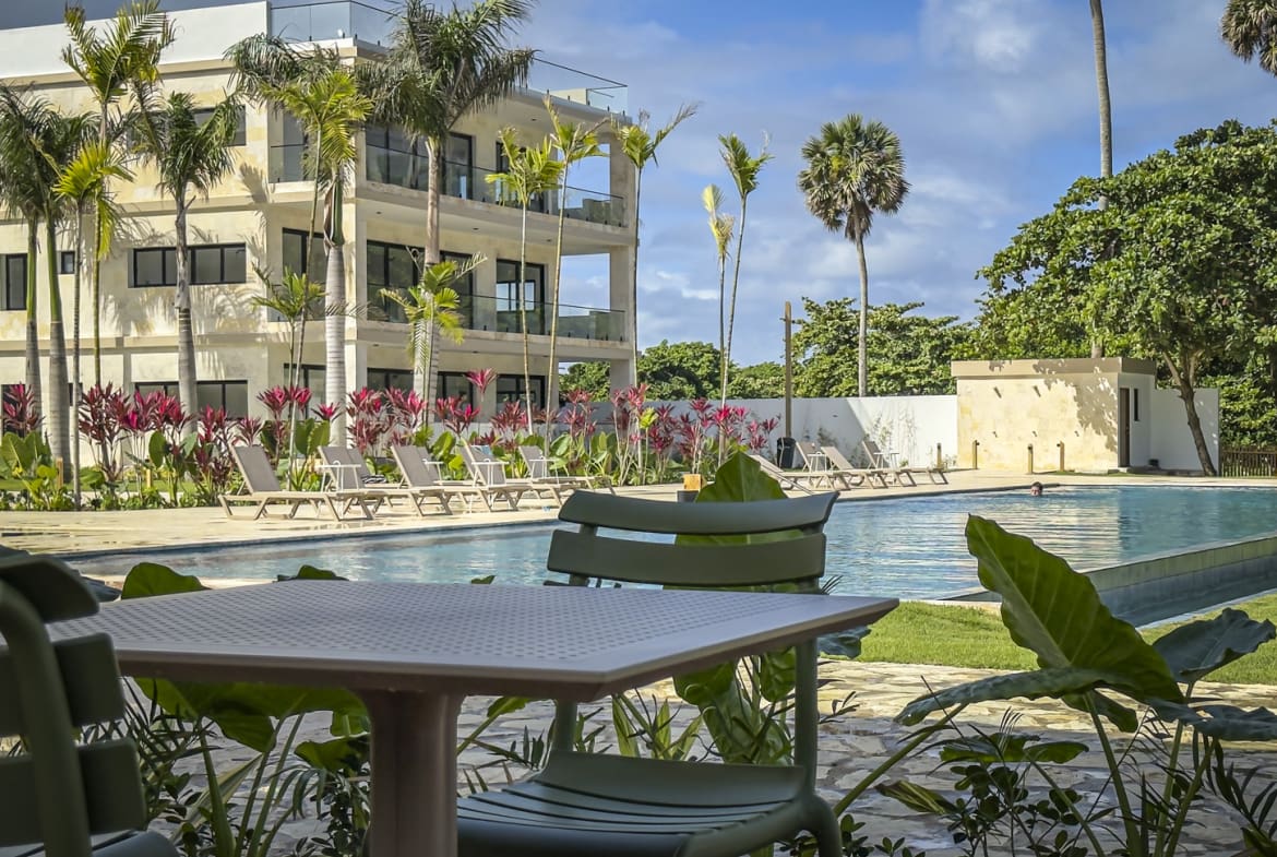 Modern resort pool with lounge chairs and tropical plants