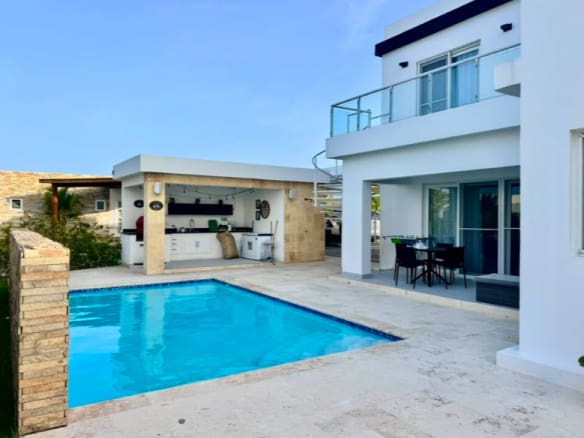 Modern villa with pool and outdoor kitchen in a tropical setting