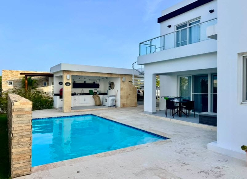 Modern villa with pool and outdoor kitchen in a tropical setting