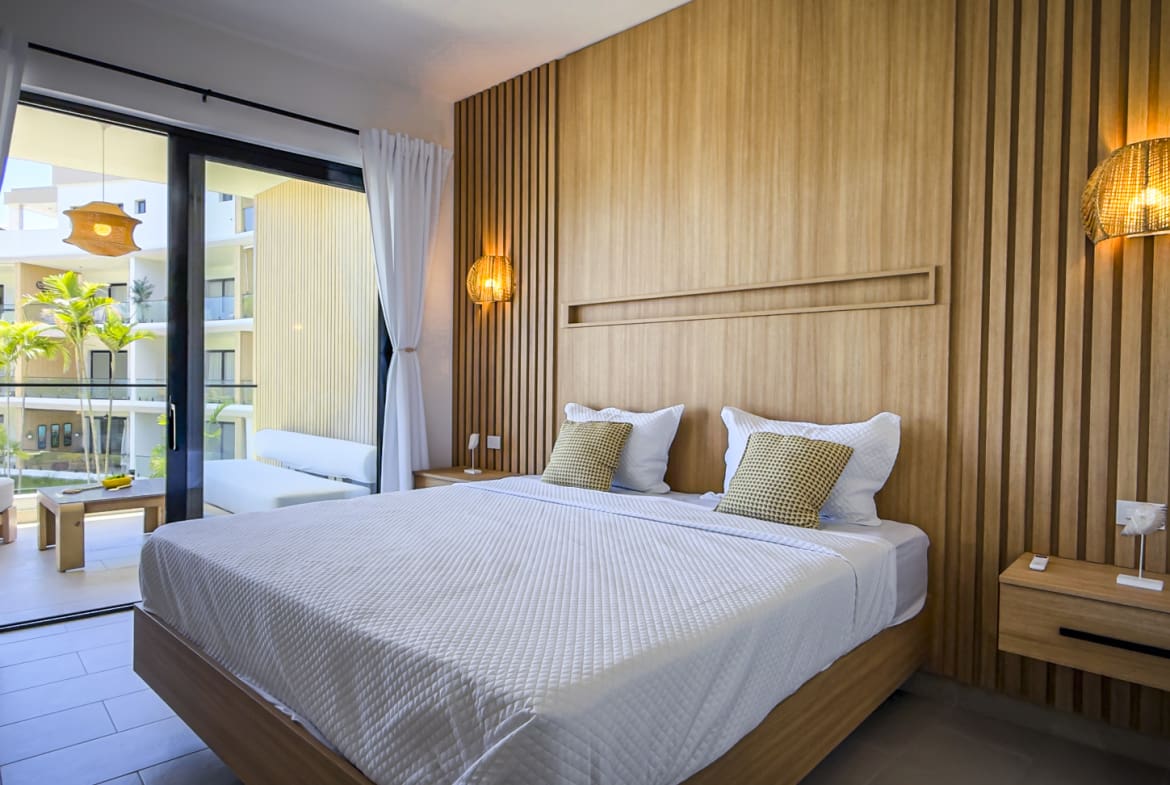 Modern bedroom with wooden accents, king-size bed, and balcony view