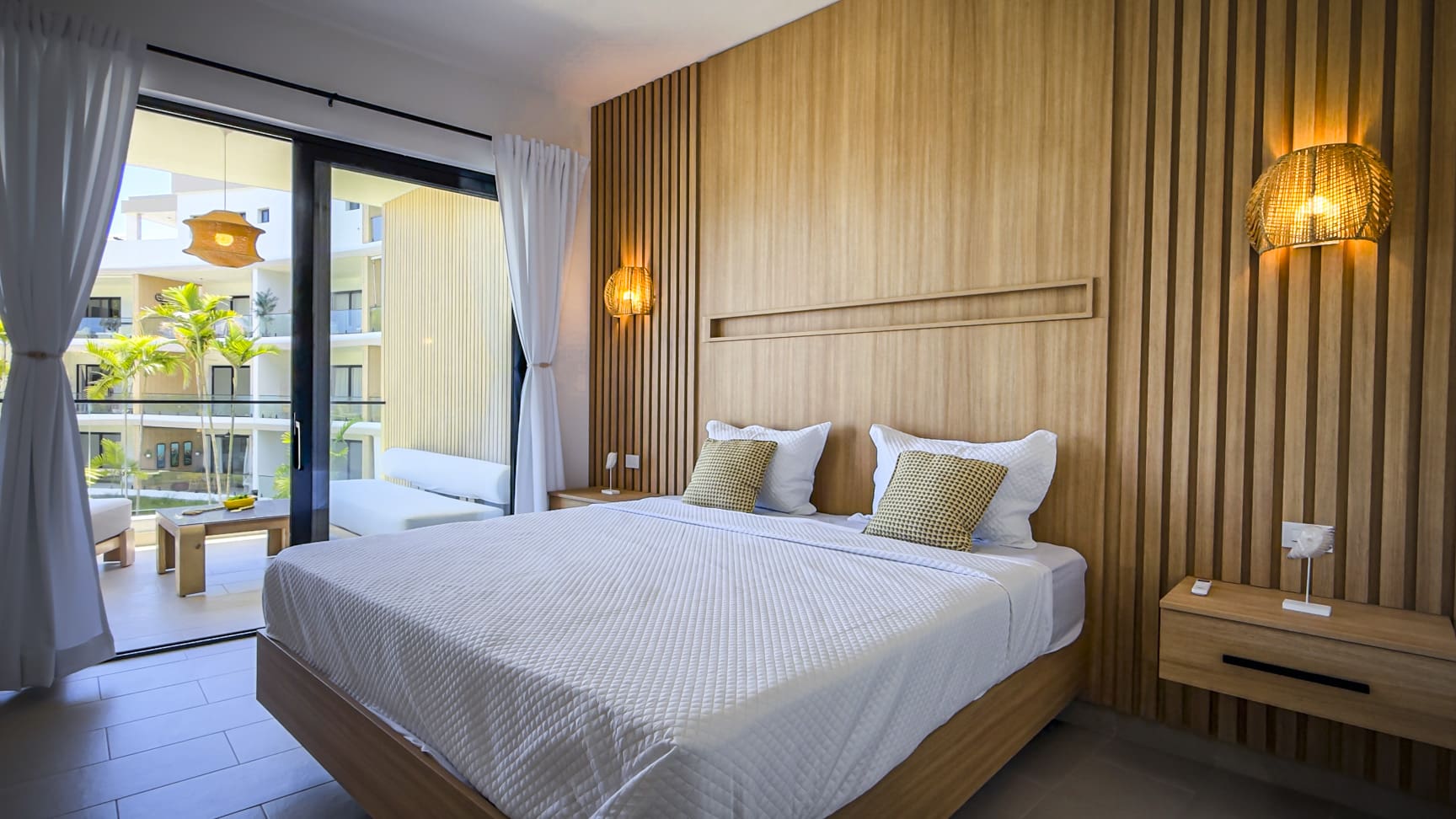 Modern bedroom with wooden accents, king-size bed, and balcony view