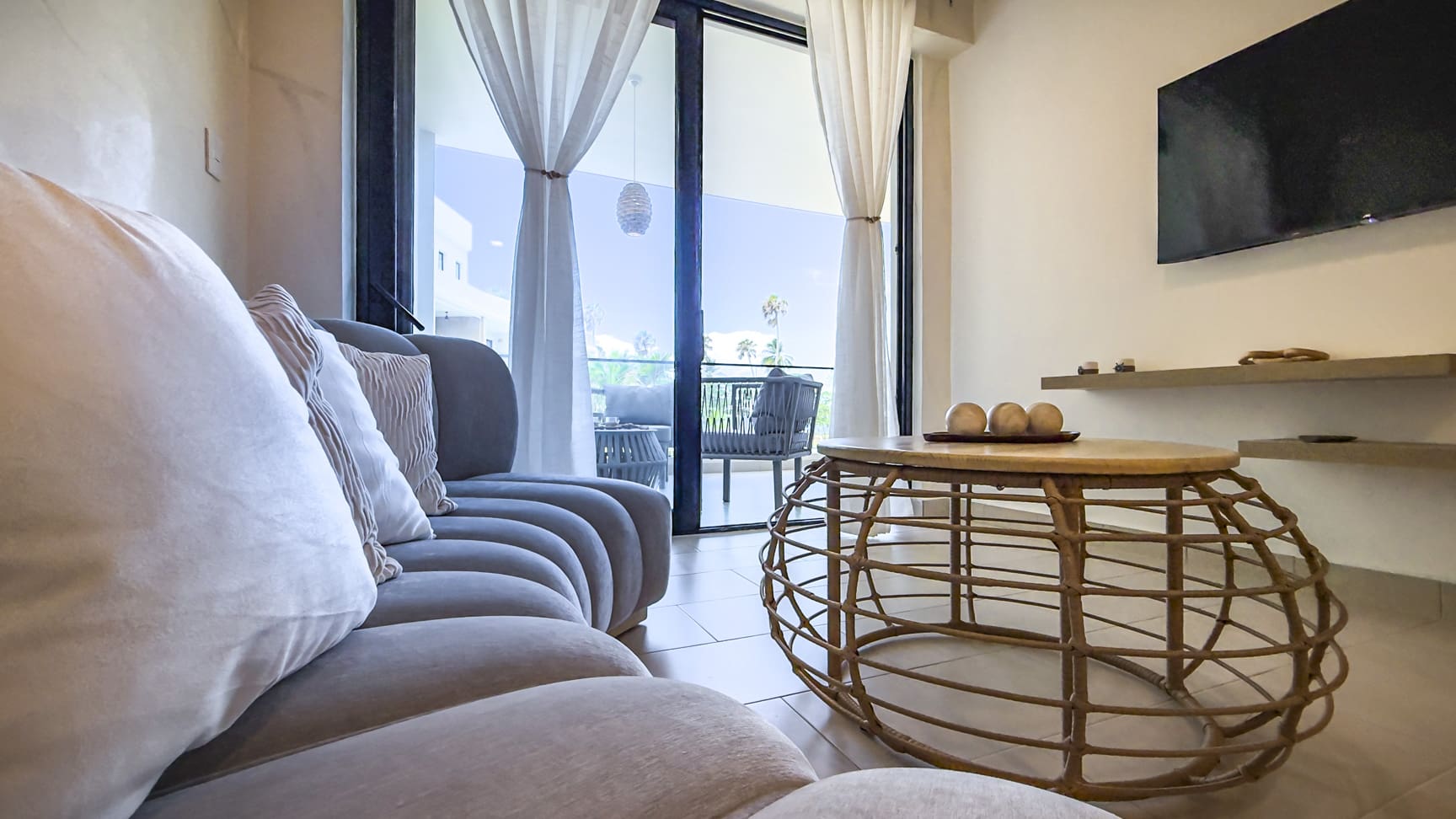 Modern living room with sofa, coffee table, and balcony view