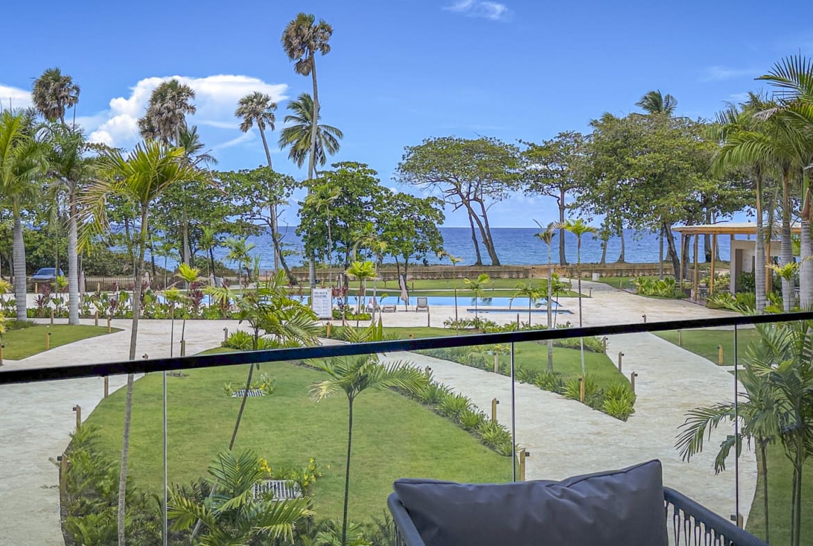 Tropical resort with palm trees, pool, and ocean view