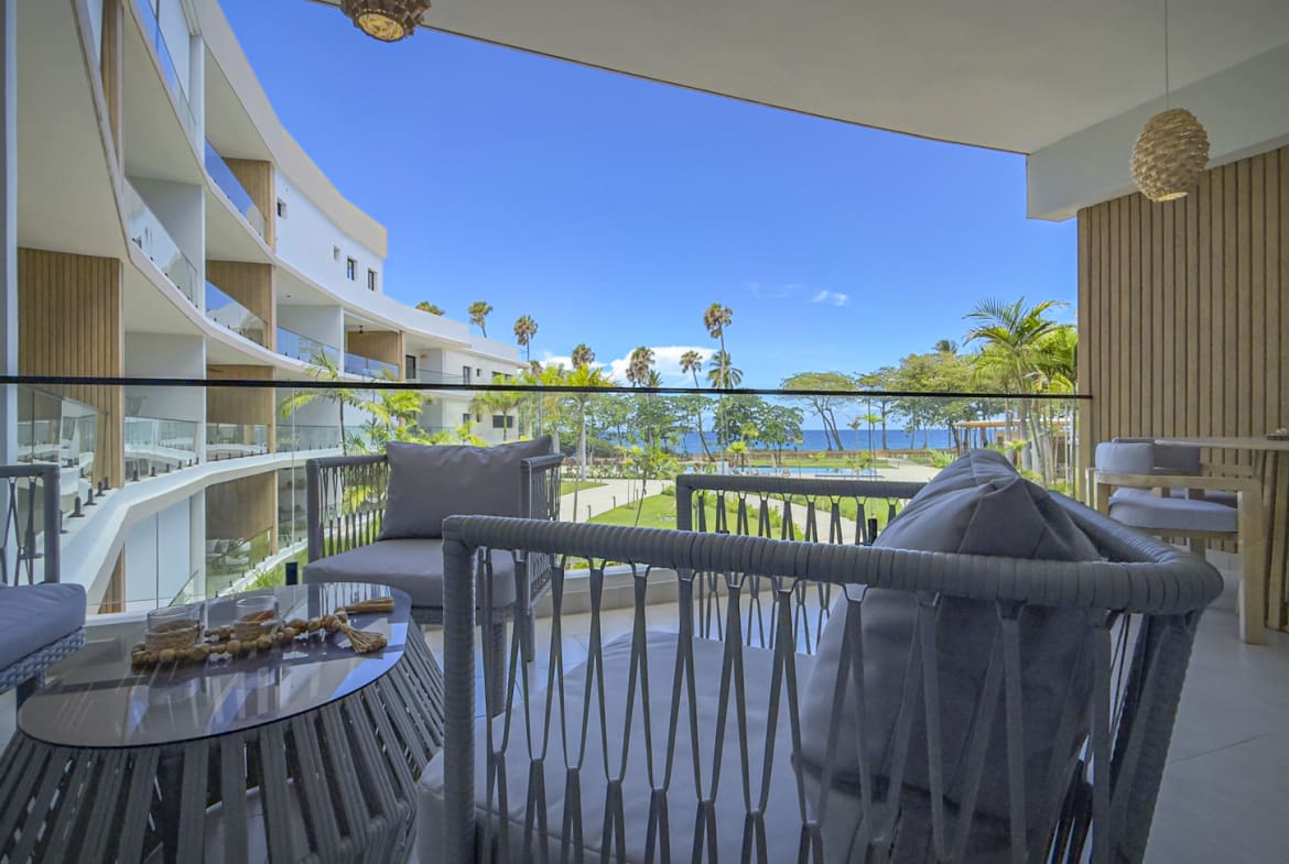 Modern balcony with seating and ocean view, resort relaxation