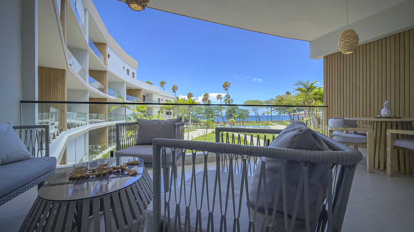 Modern balcony with seating and ocean view, resort relaxation