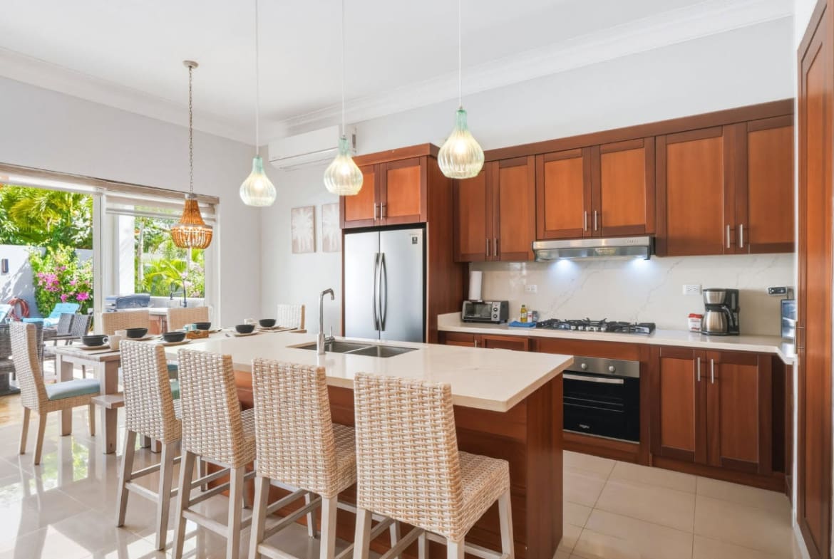 Modern kitchen island with bar stools and stainless steel appliances