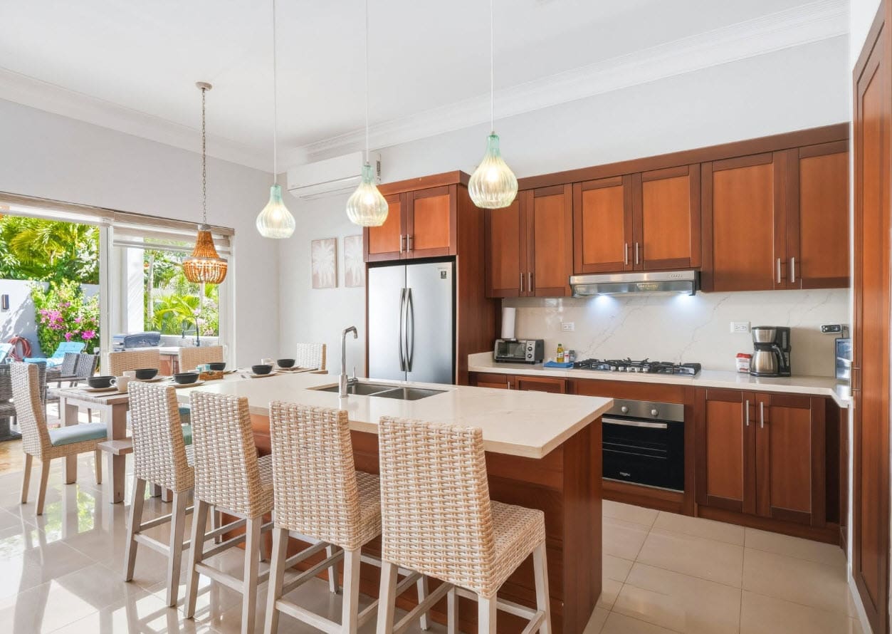 Modern kitchen island with bar stools and stainless steel appliances