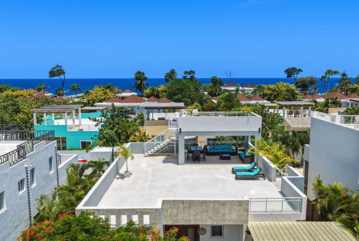 Modern white villa with rooftop terrace and ocean view in tropical paradise