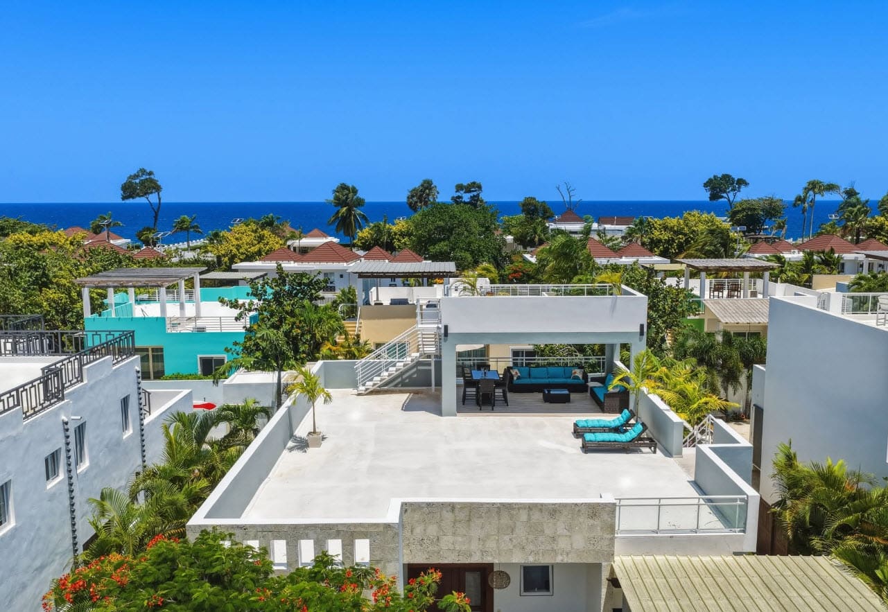 Modern white villa with rooftop terrace and ocean view in tropical paradise