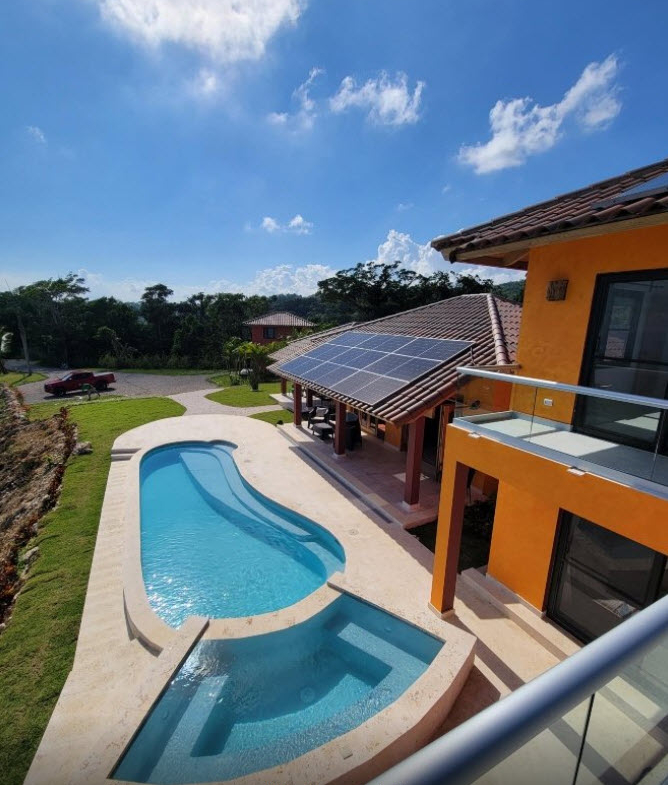 Modern villa with swimming pool, hot tub, and solar panels