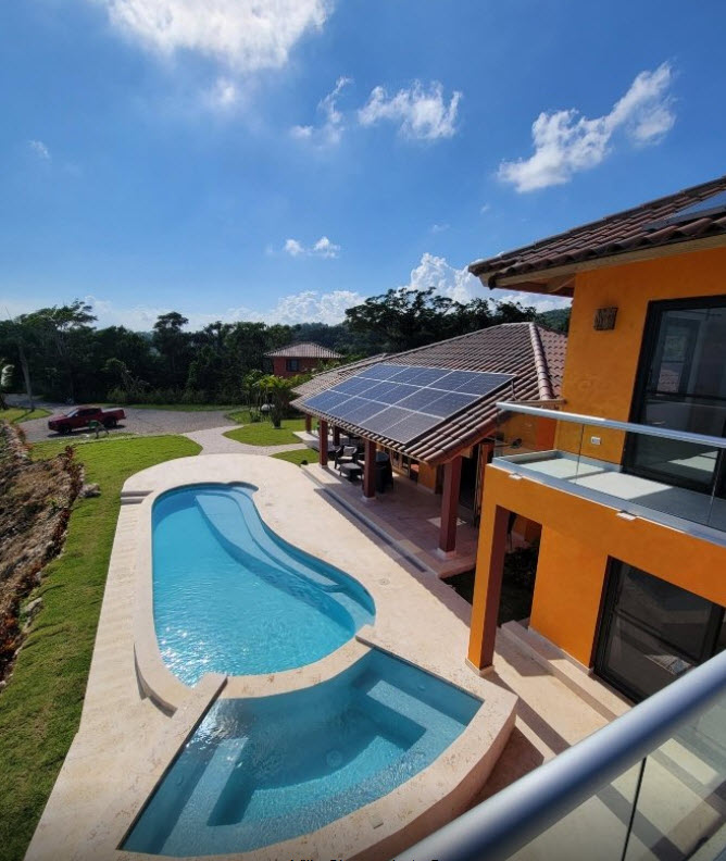 Modern villa with swimming pool, hot tub, and solar panels