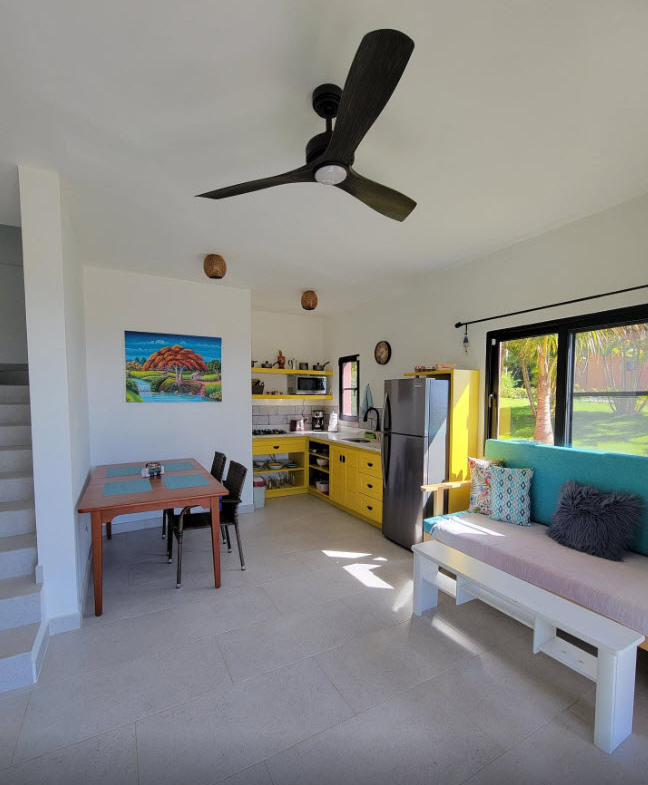 Bright, modern studio apartment with kitchen, dining area, and living space.