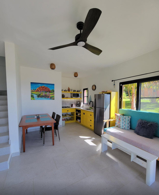 Bright, modern studio apartment with kitchen, dining area, and living space.