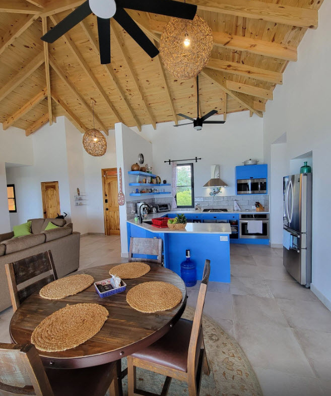 Bright, open-plan kitchen and dining area with vaulted wooden ceiling