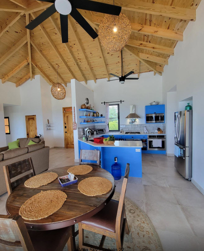 Bright, open-plan kitchen and dining area with vaulted wooden ceiling