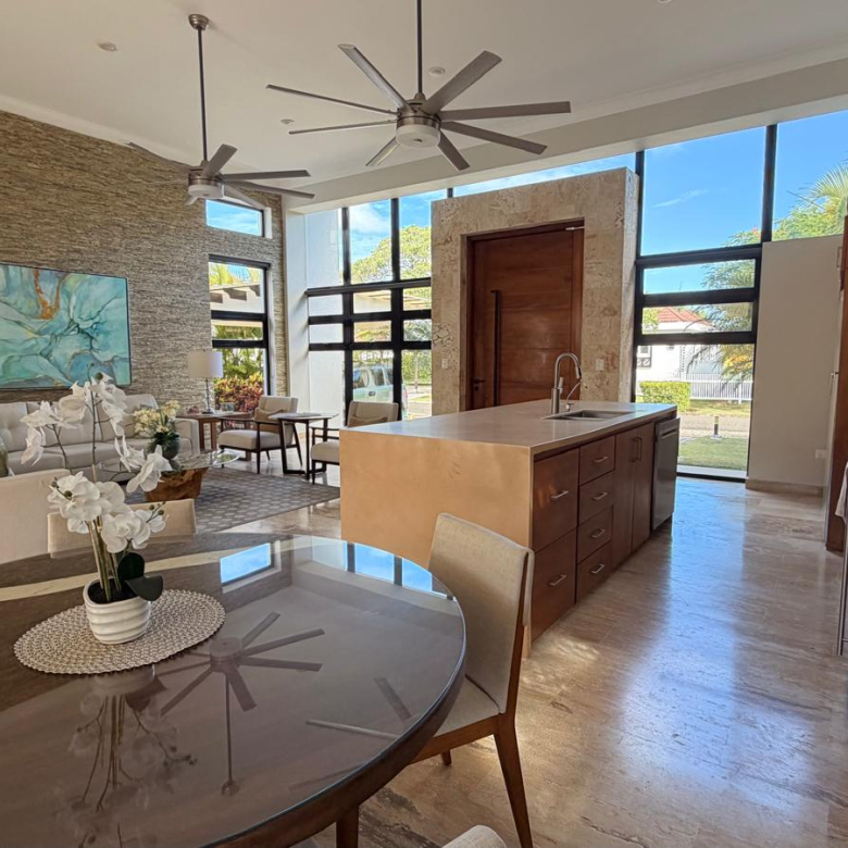 Modern open-plan living and kitchen area with large windows and island
