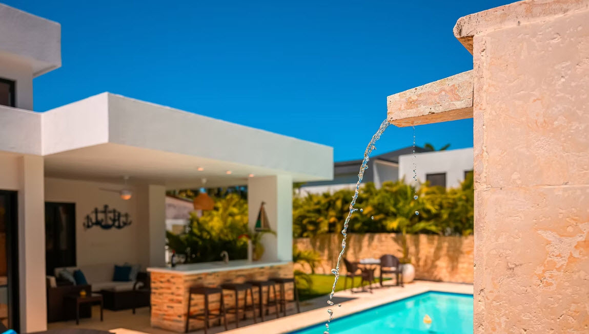 Modern villa with pool and outdoor bar on a sunny day