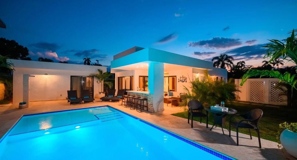 Modern villa with pool and bar at dusk